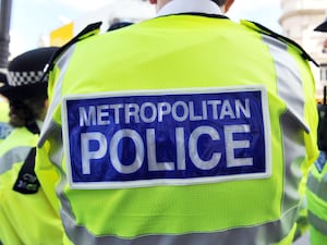 A Metropolitan Police badge on the back of a high-viz jacket