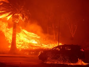 Car driving past flames