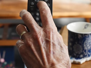 A hand on a remote control