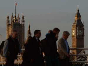 Commuters in London with Big Ben and the Houses of Parliament in the background