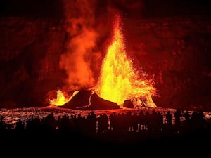 A fountain of lava spews from a volcano