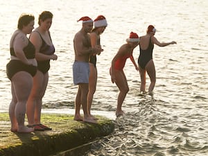 A group of people getting in the sea