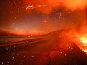 The Palisades fire burns a beachfront property in Malibu, California