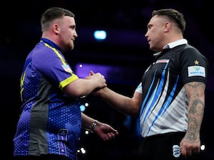 Luke Littler embraces Gerwyn Price