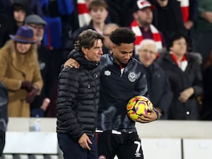 Thomas Frank and Kevin Schade in discussion as the latter holds the match ball