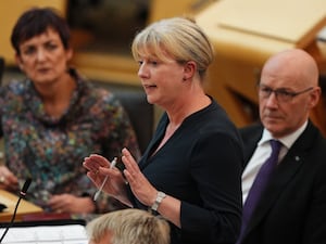 Shona Robison standing while speaking in Holyrood