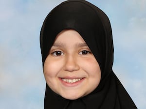 A portrait photo of Sara Sharif, smiling at the camera