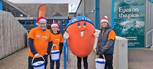 Volunteers as one of Acorn's bucket collectors as you support their important mission