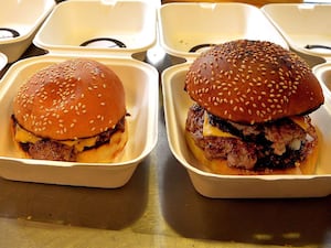 Two burgers in takeout boxes