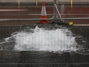 A burst water main on Victoria Street in Westminster (PA)