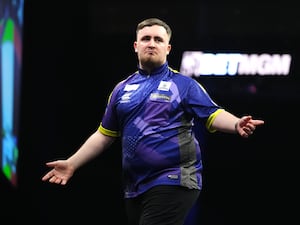 Luke Littler celebrates at a darts tournament