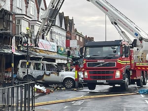 The remains of a burnt out car at the scene of a fire at a mixed commercial and residential premises on Stratford Road in Sparkhill, Birmingham. Photo: Matthew Cooper/PA Wire