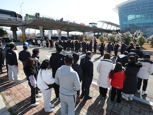 Mourners wait to pay tribute to the plane crash victims at a memorial altar at Muan International Airport in South Korea