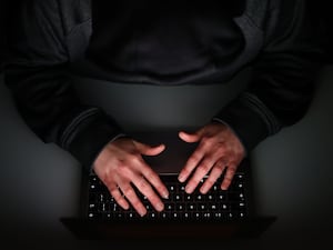 Hands typing on a keyboard